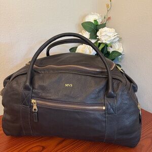 Black Duffel Bag with Gold-Toned Zipper and Structured Shape